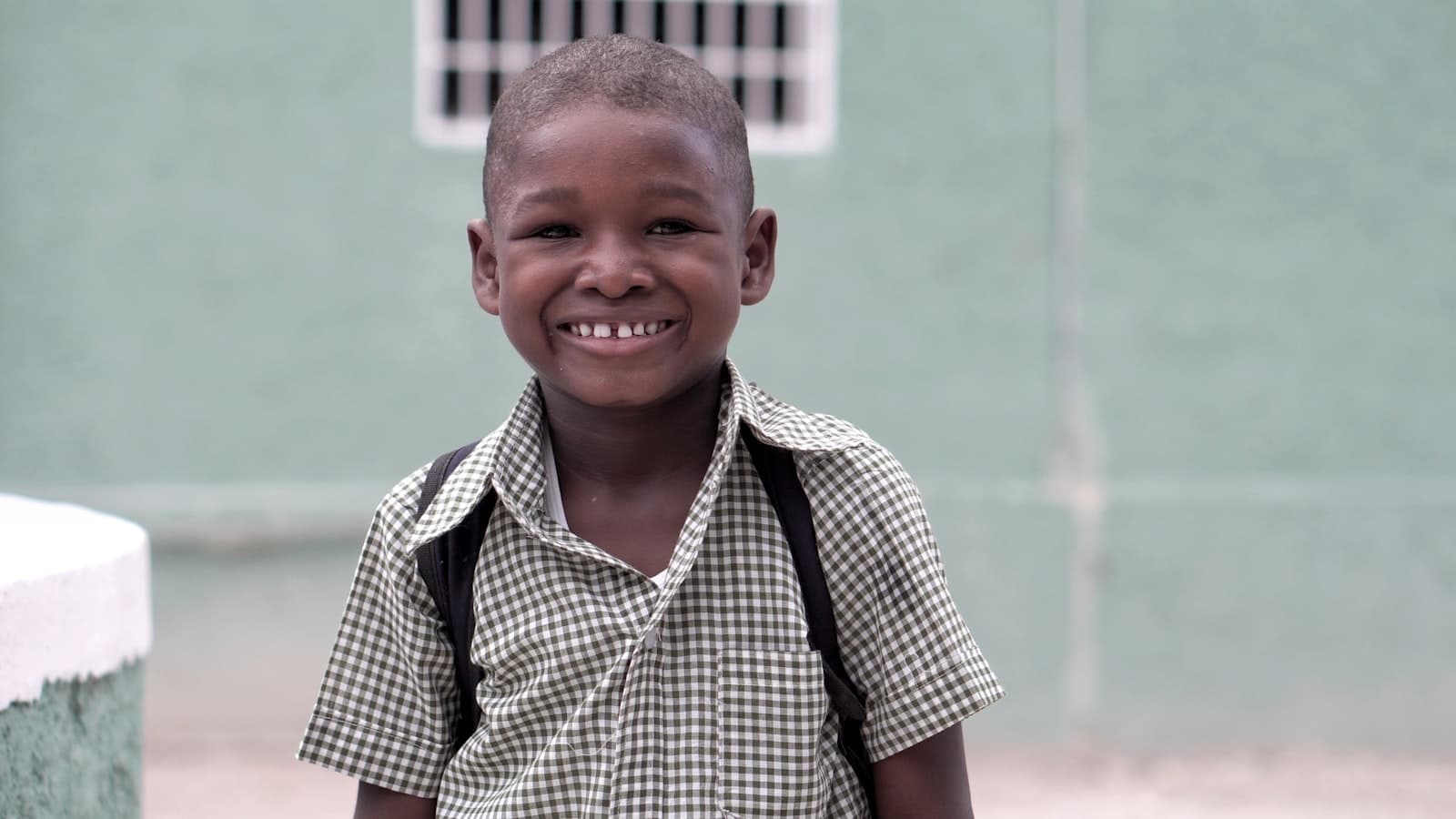 A confident child wearing a backpack, ready for school