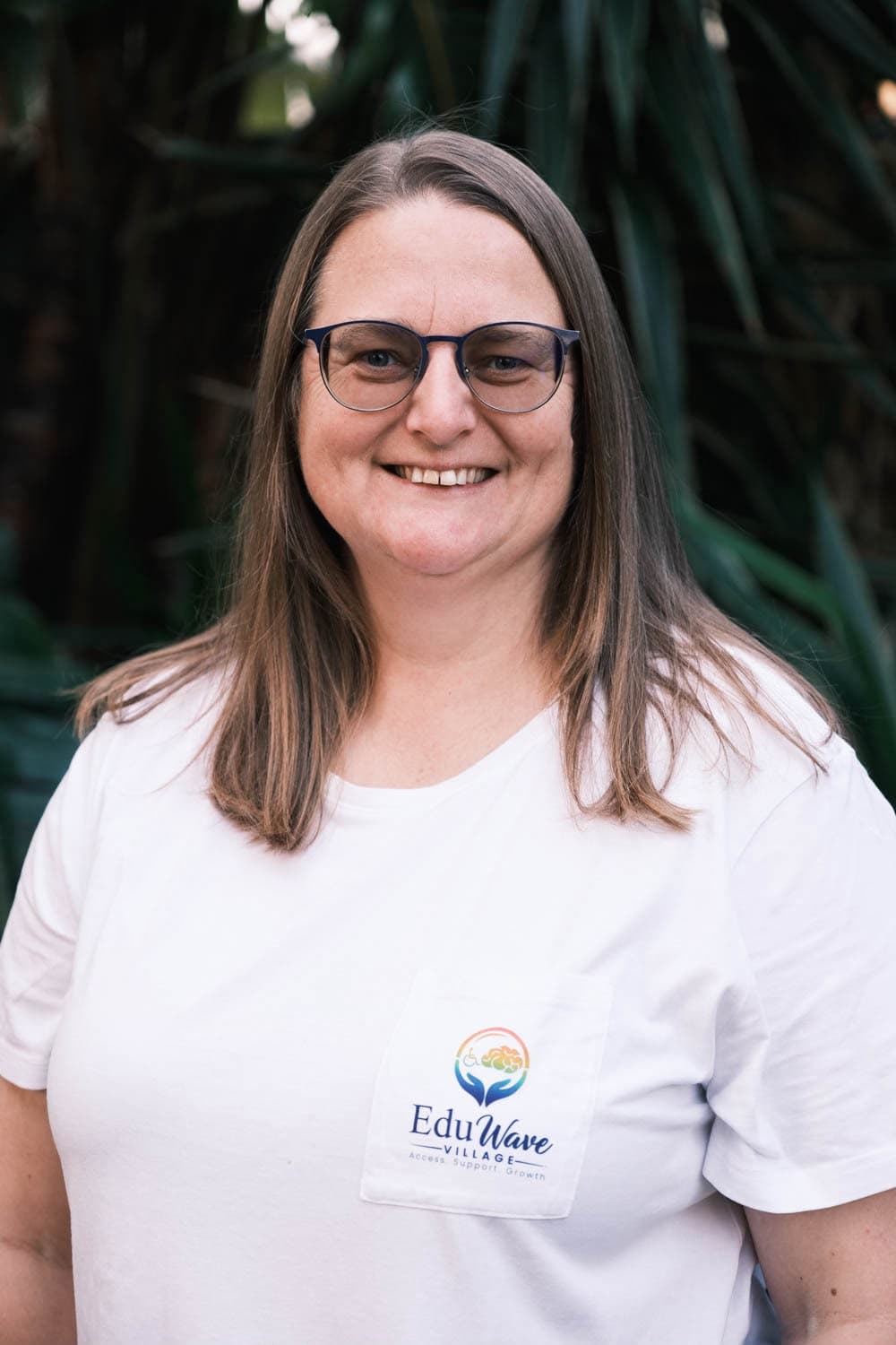 Shizelle Higgo, founder of EduWave Village, smiling in an EduWave Village t-shirt
